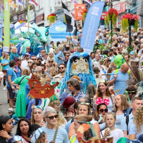 Golowan Festival June 2025 On the crest of a wave parades and crowds free event Cornwall (c) Penzance Council Sea Dragon and crowds